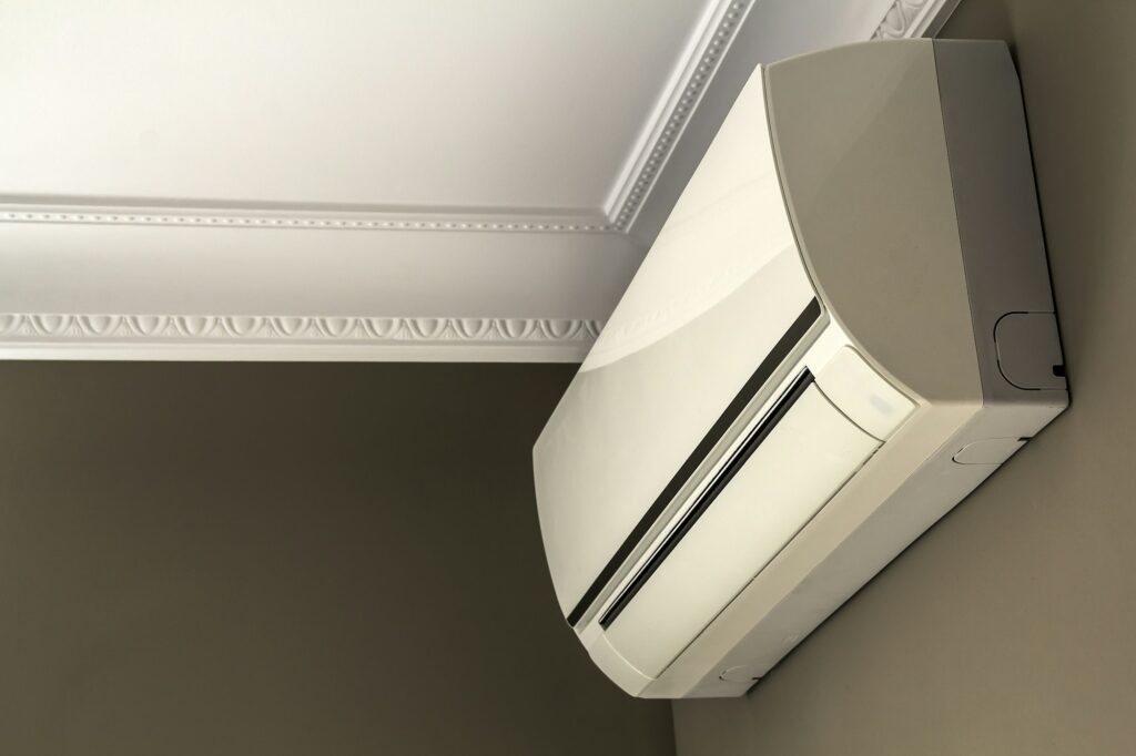 Cool air conditioner system on dark wall in room interior